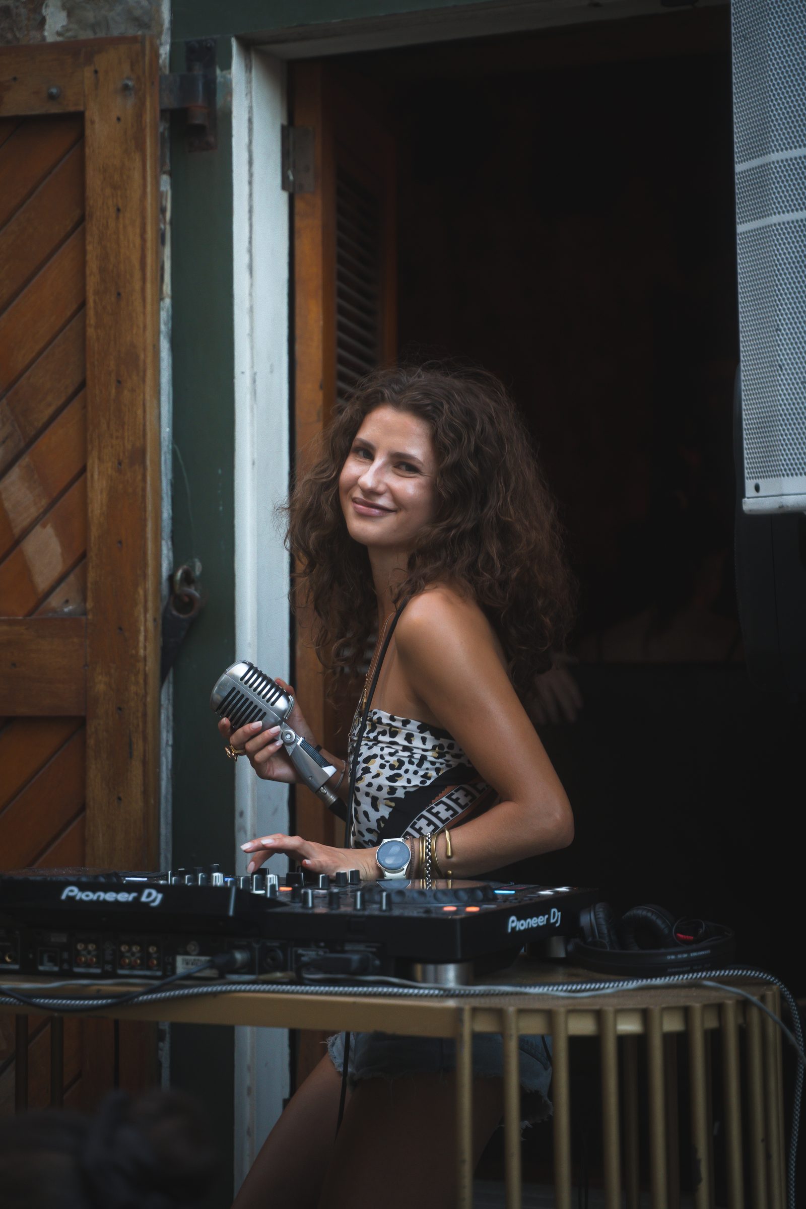 M!A LI'EL in the DJ booth with microphone